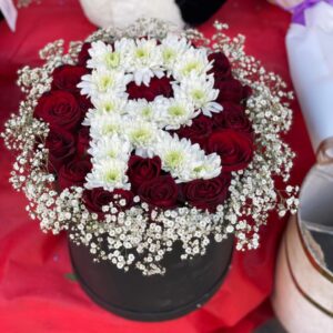 Round box of natural red roses with letter R